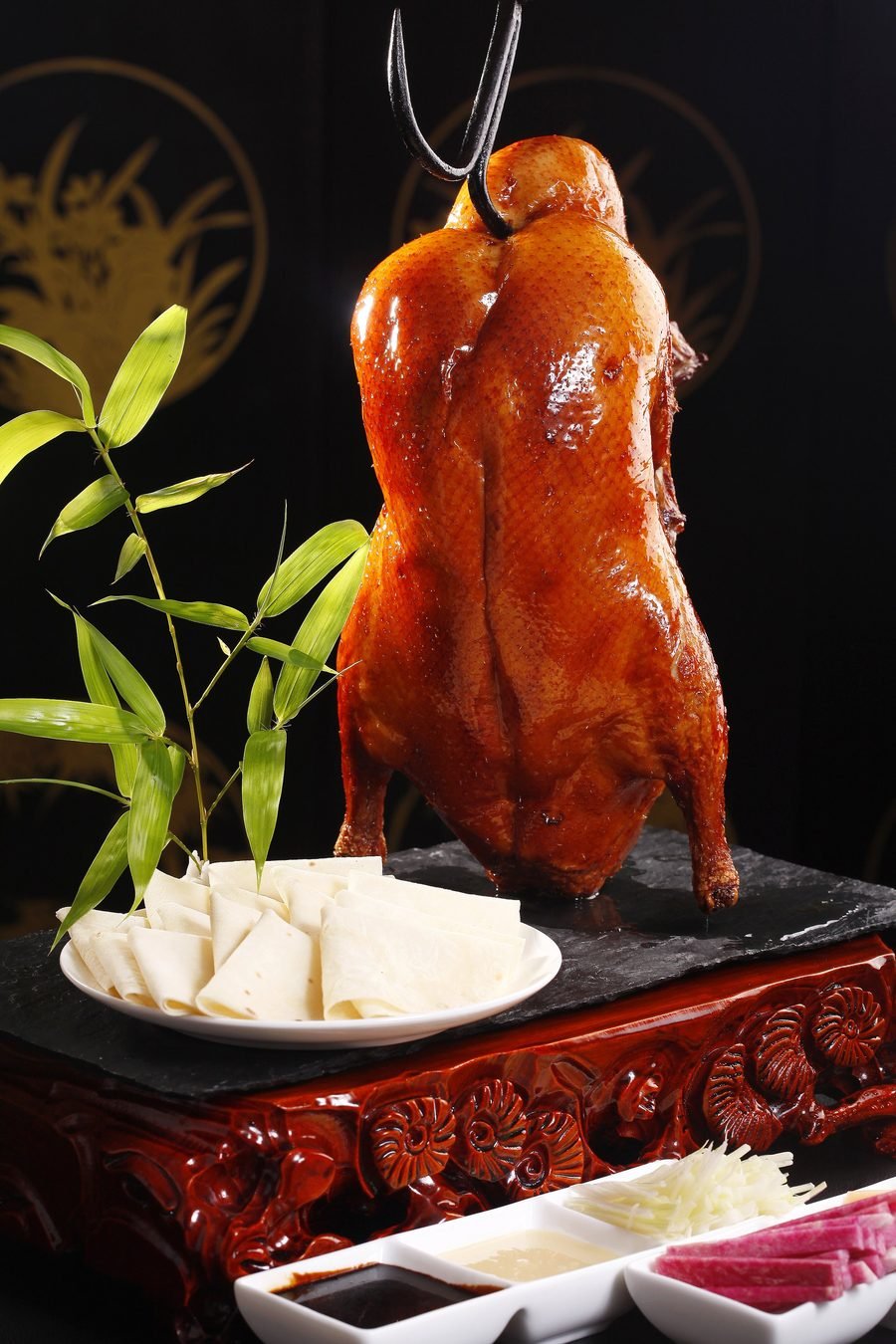 Whole roasted Peking duck, glossy and ready to carve